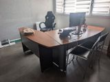 a desk with a chair and a computer on it