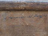 a close up of a piece of wood with writing on it