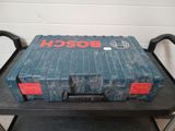 a blue tool box sitting on top of a black cart