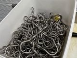 a white container filled with a bunch of metal hooks