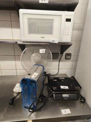 a microwave and a fan on the counter in the kitchen