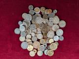 a pile of coins sitting on a red cloth