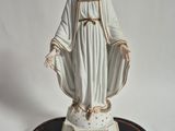 figurine of a woman in a white dress with a crown on her head