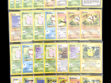 a lot of pokemon cards that are on the table