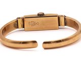 a close up of a gold bracelet with a metal clasp
