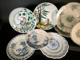a lot of plates that are sitting on a table
