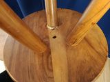 a wooden umbrella stand with three wooden umbrellas on top of it