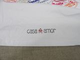 a white bag with stamps on it sitting on a couch
