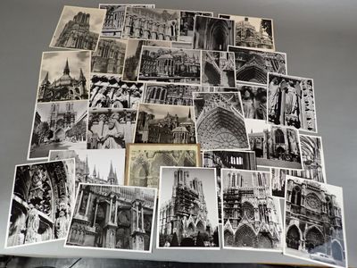 many black and white pictures of buildings on a table