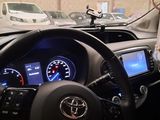 a woman that is sitting in the driver ' s seat of a car