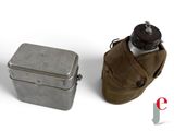 a small metal container with a water bottle next to it