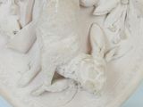 a sculpture of a bird on a plate on a table
