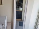 a mirror in the corner of a room next to a microwave