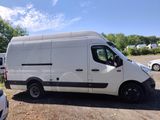 a white van parked in a parking lot with other cars