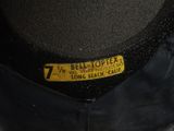 a black hat that has a yellow label on it
