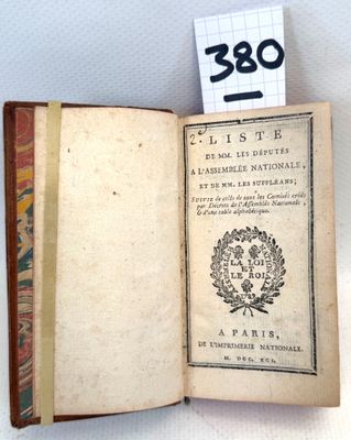 an open book with a label on it sitting on a table