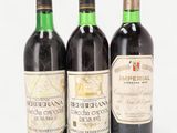 three bottles of wine sitting next to each other on a table