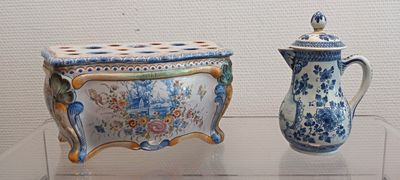 two vases that are on display on a table