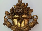 a gold vase with flowers on it on a table