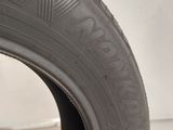 a close up of a tire on a white surface