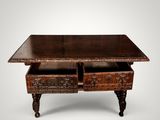 an old wooden table with two drawers on top of it
