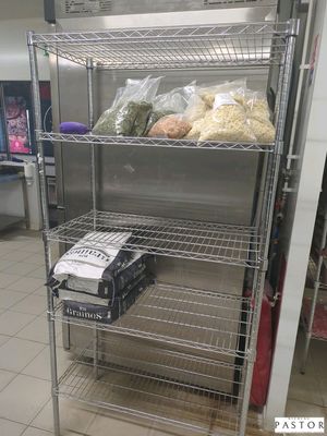une étagère métallique sur laquelle sont posés des aliments, dans une cuisine