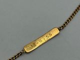 a gold plated necklace with a bar on a chain