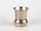 a silver cup that is sitting on a table