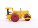 a yellow toy tractor with a man sitting in it
