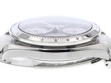 a close up of a watch on a white surface