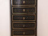 an image of a black and gold chest of drawers in a room