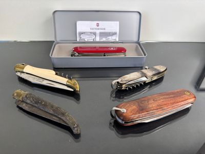 several different types of swiss army knives are on a table