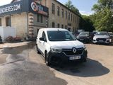 a white van parked in front of a building