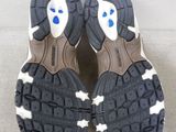 pair of black and white shoes with blue eyes on a white surface