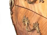 a wooden chest of drawers with ornate carvings on it