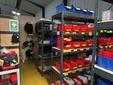 a room with a lot of shelves and bins on the shelves