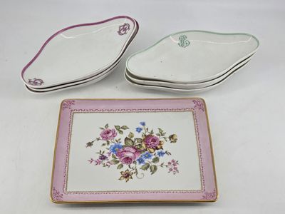 two plates with flowers on them are sitting on a table