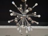 a chandelier in the middle of a room with a black ceiling