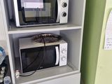a microwave and a microwave oven in a small room