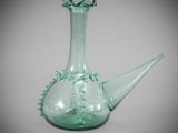 a green glass vase with a water spout in it