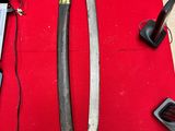 a picture of a pair of swords sitting on a table