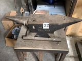an old metal anvil on a table in a workshop