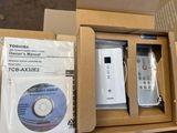 boxes containing a remote, a dvd, and a cd in a cardboard box
