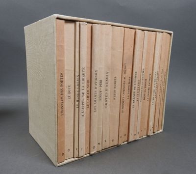 six books are stacked on top of each other in a cardboard box