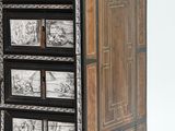 a black and white chest of drawers with pictures on it