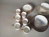 a lot of cups and saucers sitting on a table