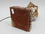 a brown box with a gold handle on a white surface