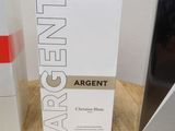two boxes of perfume sitting on a wooden table next to each other