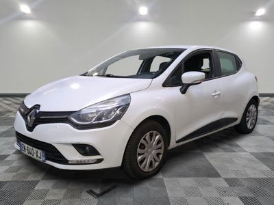 the white car is parked on a checkered tile floor
