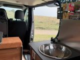 a small kitchen in the back of a camper van